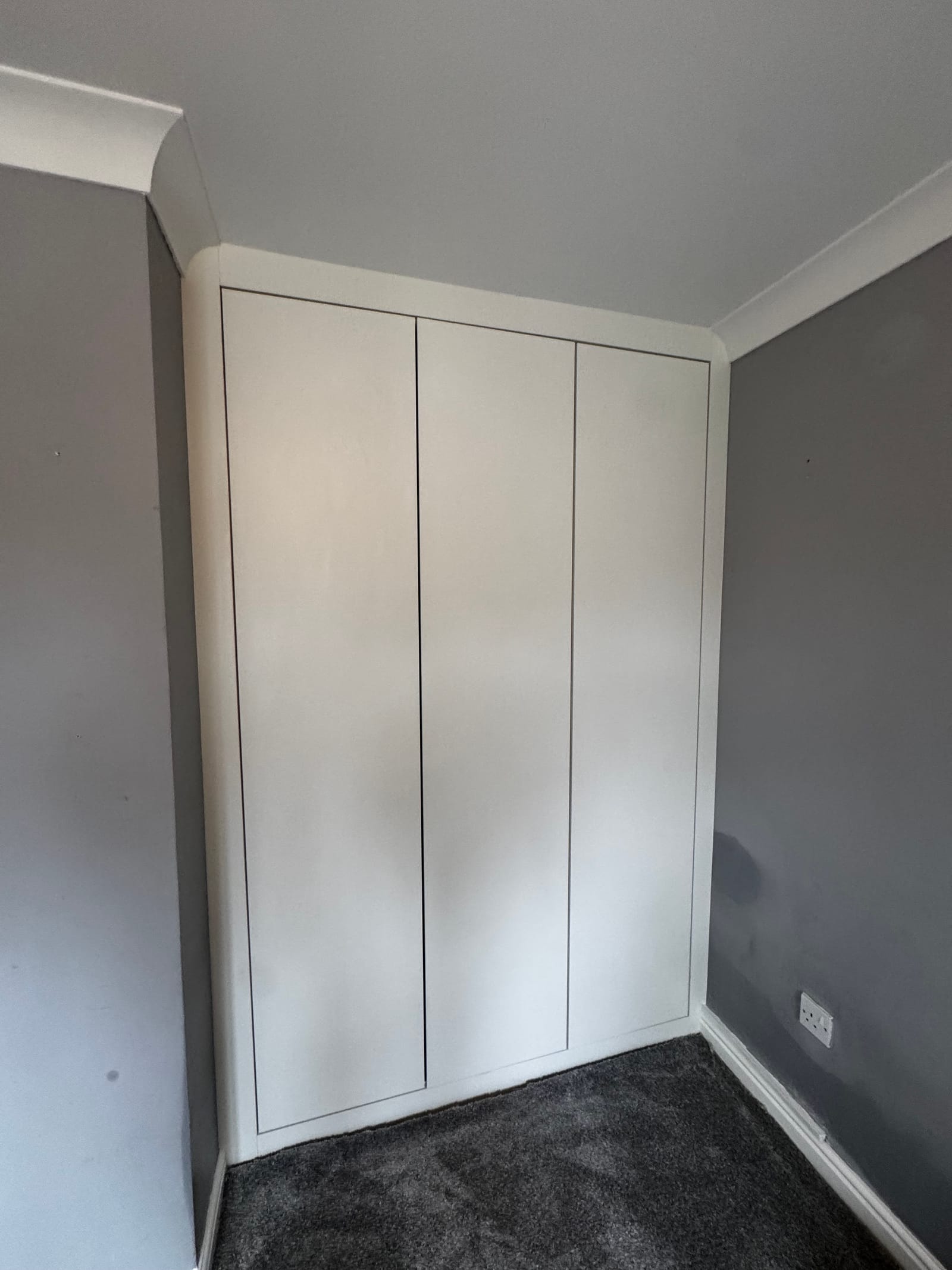 Close detail of bespoke white drawer fronts showing precision shadow gaps