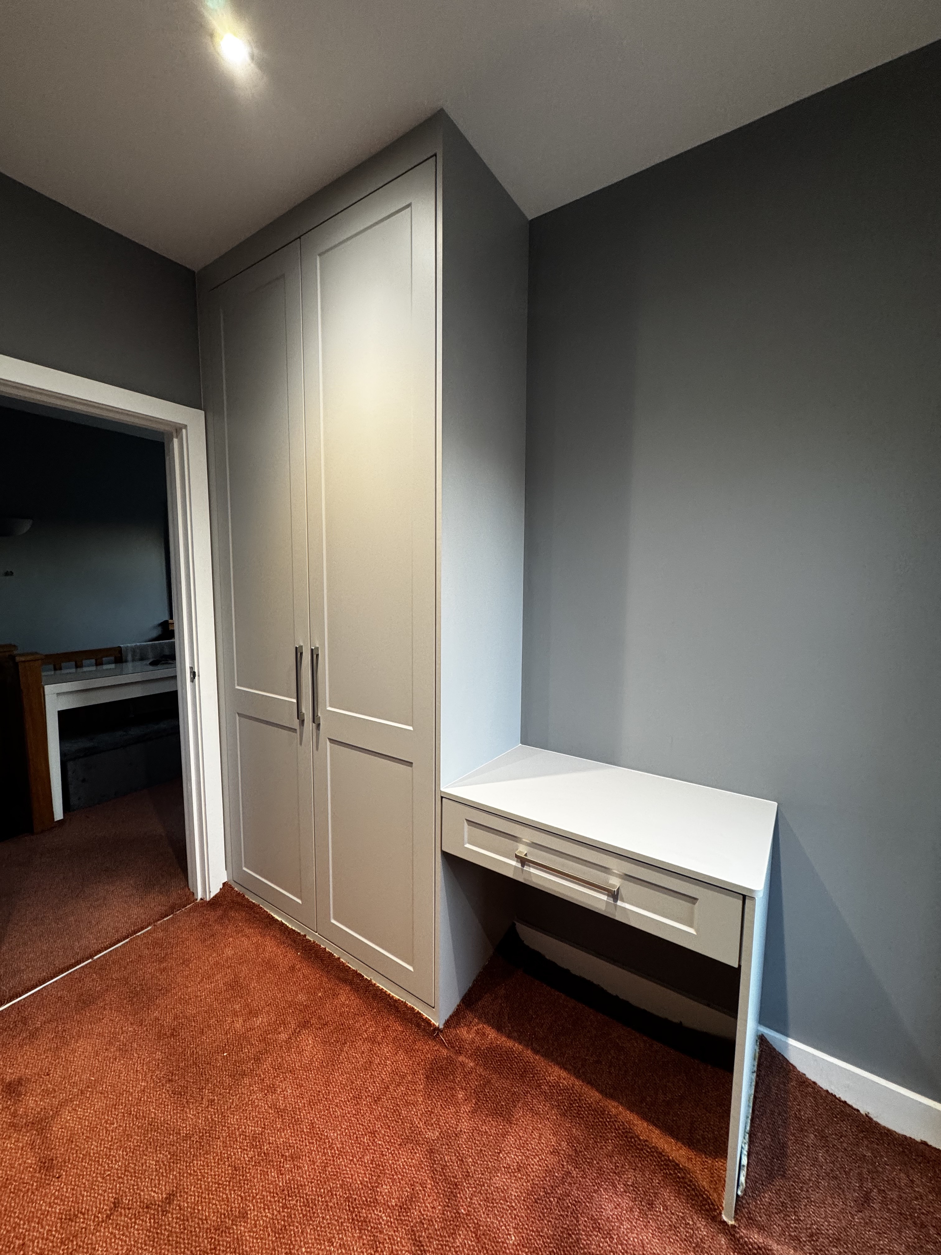Grey shaker fitted wardrobe with floating dressing-table desk in a Birmingham bedroom