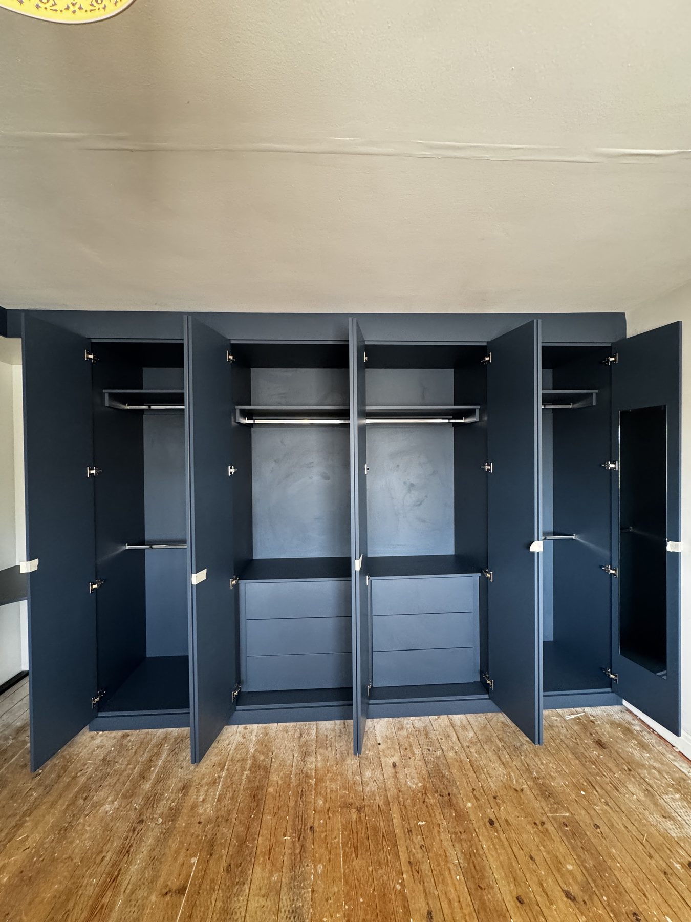 Interior of Alby Blue fitted wardrobes with chrome hanging rails and internal drawers, Birmingham