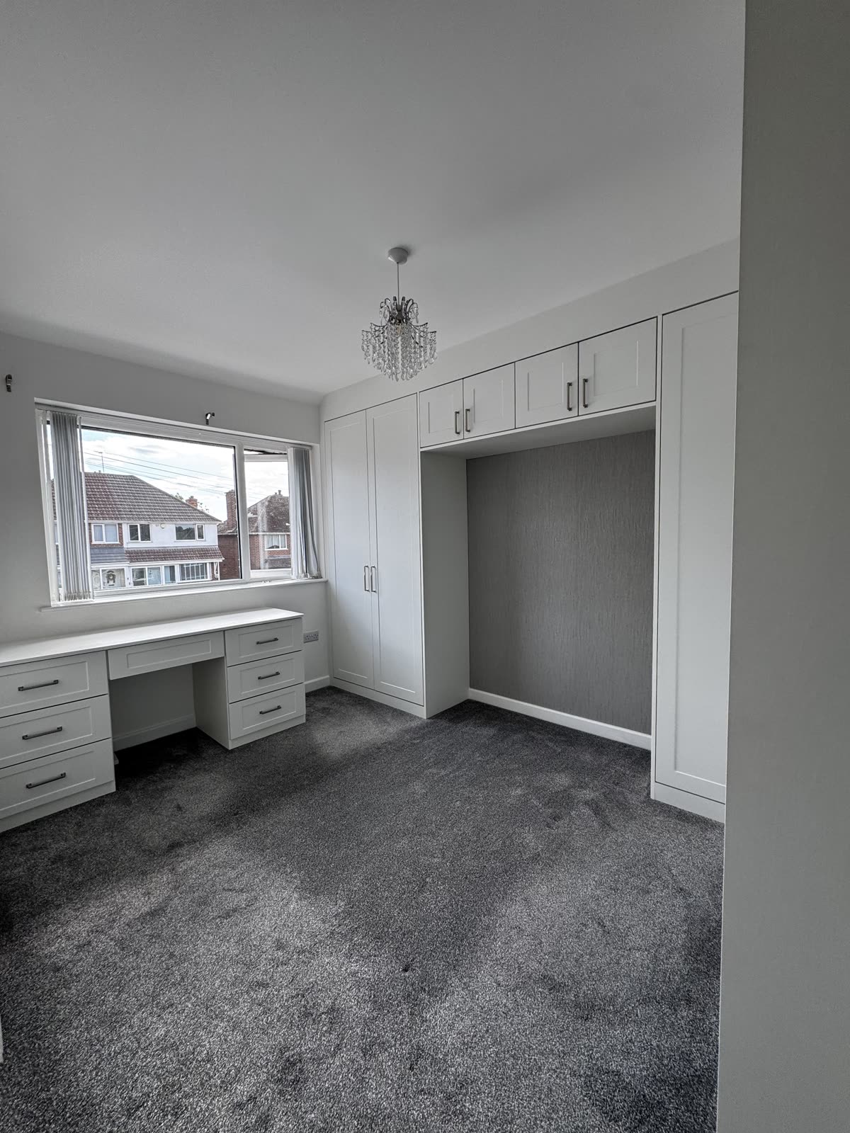 Full bedroom fitted by SM Bespoke Interiors: white shaker wardrobes, bridging cupboards and a built-in desk with drawers